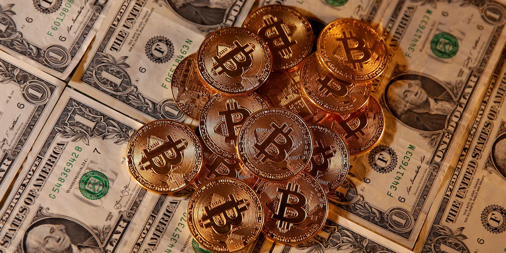 FILE PHOTO: Representations of virtual currency Bitcoin and U.S. dollar banknotes are seen in this picture illustration taken January 27, 2020. REUTERS/Dado Ruvic